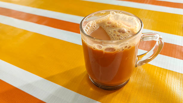 Teh Tarik, a traditional hot milk tea, is a beloved breakfast beverage in Malaysia known for its frothy pull and rich flavor.